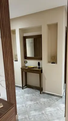 a room with a table and a mirror on the wall at Le Marrakchi - 2 chambres - Parking - Wifi in Marrakech