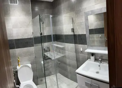 a bathroom with a shower and a toilet and a sink at Le Marrakchi - 2 chambres - Parking - Wifi in Marrakech
