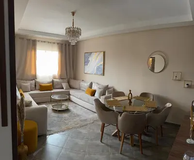 a living room with a couch and a table at Le Marrakchi - 2 chambres - Parking - Wifi in Marrakech