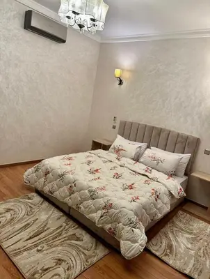 a large bed in a bedroom with a rug at Apartment in Marrakech equipped and comfortable in Marrakech