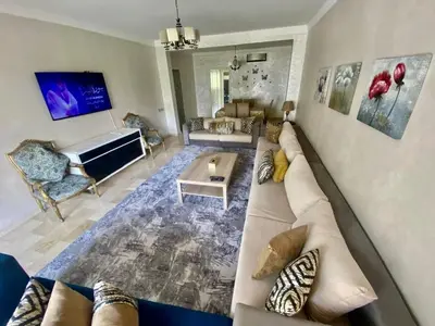 a large living room with a couch and a table at Apartment in Marrakech equipped and comfortable in Marrakech