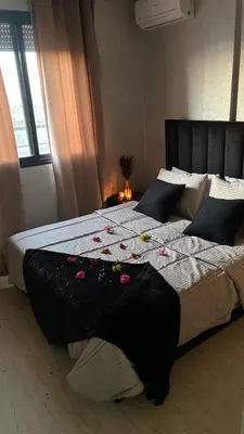 a bedroom with two beds with flowers on them at Etoile rouge in Marrakech