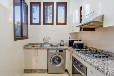 a kitchen with a washing machine and a sink at Villa Waky Confort & Relax in Marrakech