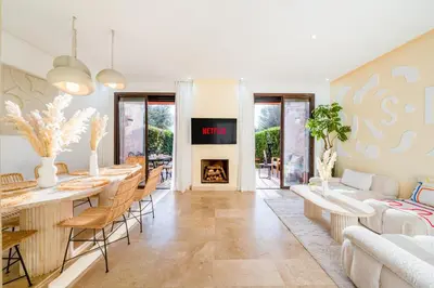 a living room with a table and a fireplace at Villa Waky Confort & Relax in Marrakech