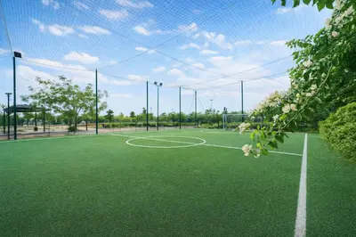 a tennis court with a net on top of it at Appartement Moderne, Vue Atlas & Piscine, Noria in Marrakech