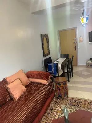 a living room with a couch and a table at Appartement Cosy & Calme à Izdihar Confort Assuré in Marrakech