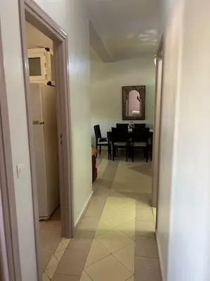 a hallway with a living room and a dining room at Appartement Cosy & Calme à Izdihar Confort Assuré in Marrakech