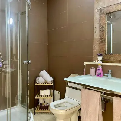 a bathroom with a shower and a toilet and a sink at Appartement Centre Gare gueliz chic et cosy de Marrakech in Marrakech