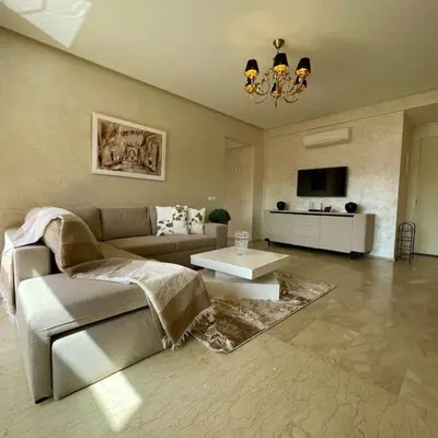 a living room with a couch and a table at Appartement Centre Gare gueliz chic et cosy de Marrakech in Marrakech