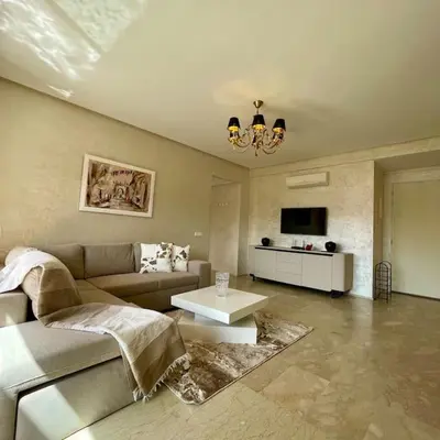 a living room with a couch and a table at Appartement Centre Gare gueliz chic et cosy de Marrakech in Marrakech
