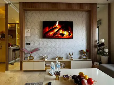 a living room with a fire on the wall at Appartement confort in Marrakech