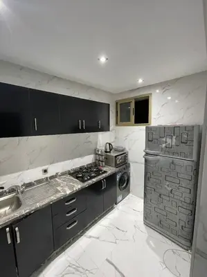 a kitchen with black and white marble counter tops at Appartement à Marrakech au cœur de guéliz in Marrakech