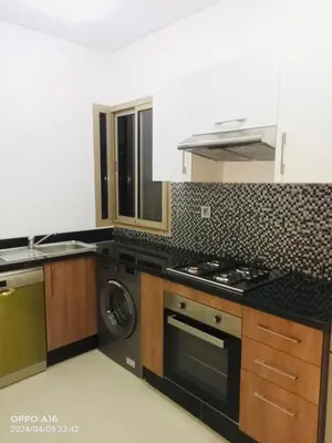 a kitchen with a stove and a washing machine at Appartement de vacances à Prestigia golf city rez jardin in Marrakech