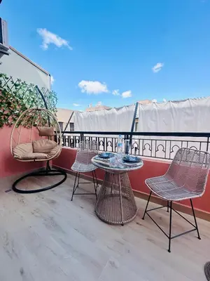 a patio with two chairs and a table on a balcony at Magnifique 1 Room WIFI en plein coeur de GUELIZ in Marrakech