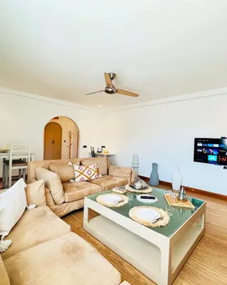 a living room with a couch and a table at Magnifique 2 chambres Terrasse et Wifi à Marrakech in Marrakech