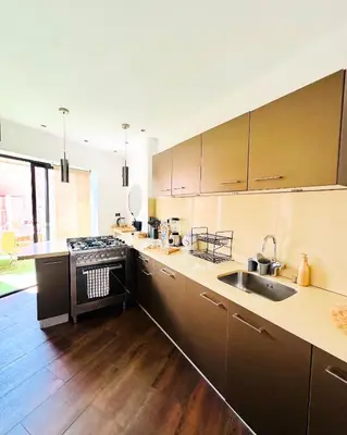 a large kitchen with a sink and a stove at Magnifique 2 chambres Terrasse et Wifi à Marrakech in Marrakech
