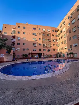 a large swimming pool in front of a building at Superbe Appartement en Résidence, Marrakech Guiliz in Marrakech