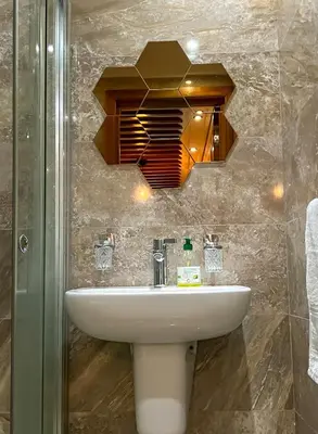 a bathroom with a sink and a mirror at Superbe Appartement en Résidence, Marrakech Guiliz in Marrakech