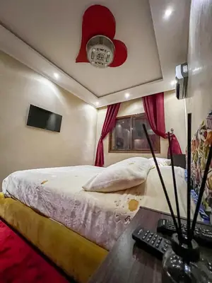 a bedroom with a bed with a skull on the ceiling at Superbe Appartement en Résidence, Marrakech Guiliz in Marrakech
