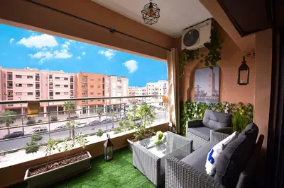 a balcony with a view of a city at Cozy Apartment in Hay Charaf district, Marrakech in Marrakech