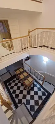 a room with a staircase with a checkerboard floor at Riad Kechin Beldi in Marrakech