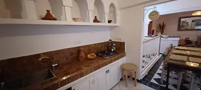 a kitchen with a sink and a counter top at Riad Kechin Beldi in Marrakech