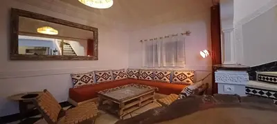 a living room with a couch and a mirror at Riad Kechin Beldi in Marrakech