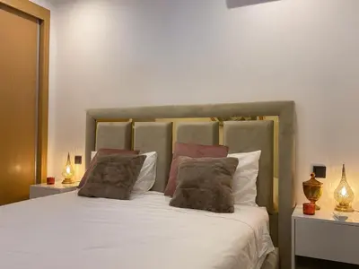 a bedroom with a large bed with white sheets and pillows at MARRAKECH Palmeraie Gates in Marrakech