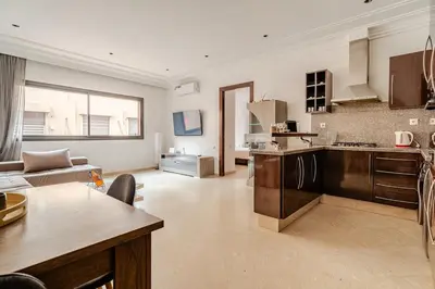 a large kitchen and living room with a couch at Cozy Studio in city center Guéliz in Marrakech