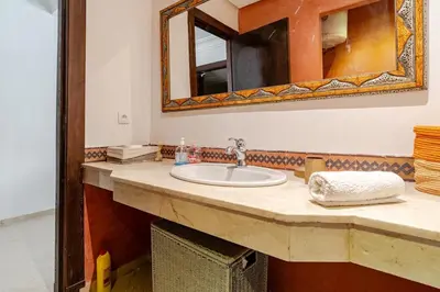 a bathroom with a sink and a mirror at Cozy Studio in city center Guéliz in Marrakech