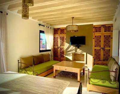 a living room with a green couch and a table at cozy appartement in Marrakech