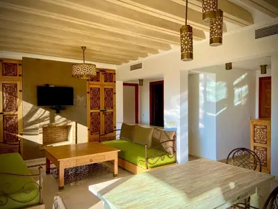 a living room with a green couch and a table at cozy appartement in Marrakech