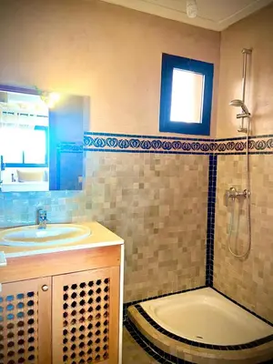 a bathroom with a tub and a sink and a shower at cozy appartement in Marrakech