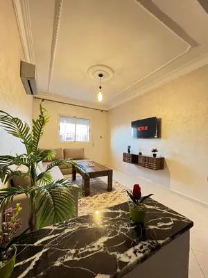 a living room with a ping pong table in a room at Cozy Apartment Near Airport in Marrakech