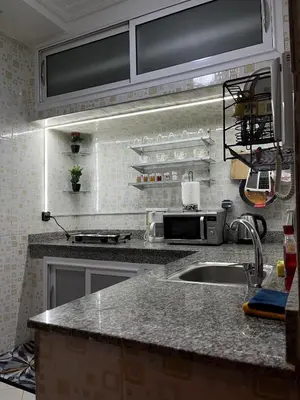 a kitchen with a sink and a counter top at Cozy Apartment Near Airport in Marrakech