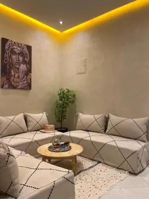 a living room with a couch and a table at Cozy Apartment Near Airport in Marrakech