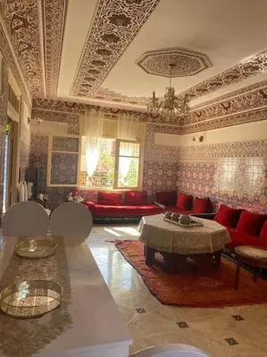 a living room with a couch and a table at La porte d Or in Marrakech
