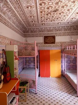 a room with two bunk beds and a ceiling at La porte d Or in Marrakech