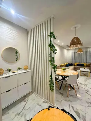 a living room with a table and a couch at La Palmeraie Luxueux avec Piscine et Parking in Marrakech