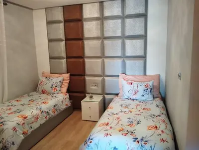 a bedroom with two beds and a window at Prestigia appartement in Marrakech