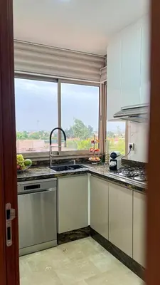 a kitchen with a sink and a window at Appartement Marrakech prestigia by Sofia 2 chambres piscine in Marrakech
