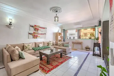 a living room with a couch and a table at Appartement Duplex confort qualité très bien situé in Marrakech