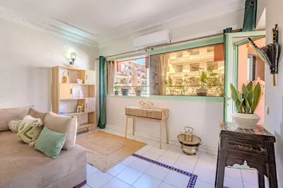 a living room with a couch and a window at Appartement Duplex confort qualité très bien situé in Marrakech