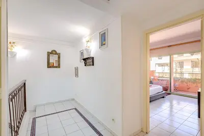 a hallway with a door leading to a living room at Appartement Duplex confort qualité très bien situé in Marrakech