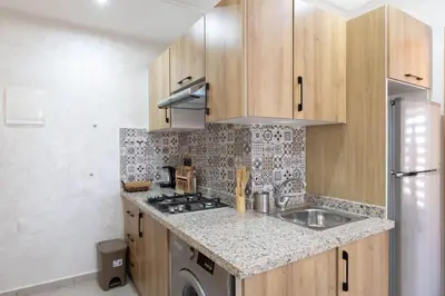 a kitchen with a sink and a stove at Studio moderne à deux pas du coeur de la ville in Marrakech