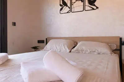 a bedroom with two beds with white sheets and pillows at Studio moderne à deux pas du coeur de la ville in Marrakech