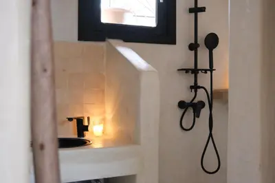 a bathroom with a sink with a candle in it at Riad Solange in Marrakech