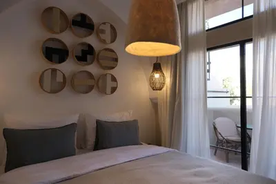 a bedroom with a bed and a window and a pendant light at Riad Solange in Marrakech