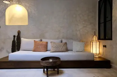 a bedroom with a bed with pillows and a table at Riad Solange in Marrakech