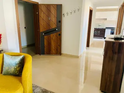 a living room with a yellow couch and a wooden door at Nomad's Cosy Apartment Gueliz Center in Marrakech